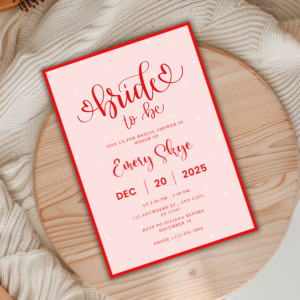 Bride to Be bridal shower invitation with red script on pink background, featuring snowflake dots, holiday-themed design editable in Canva.