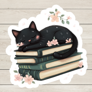 Die-cut sticker of a black cat sleeping on vintage green books with pink flowers and soft pastel accents