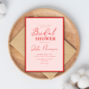 Elegant pink and red bridal shower invitation with snow-like dots, modern script and serif fonts, editable text in Canva for customizable celebration.